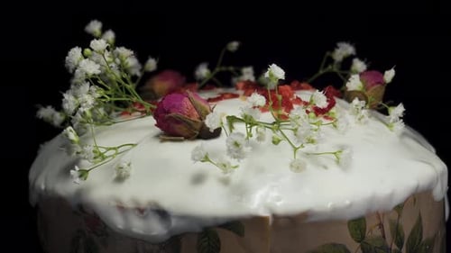 Easter cake with roses and white flowers on a black background. Rotates close-up.