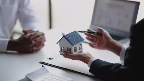 Close up of business's hands selling and buying for house.