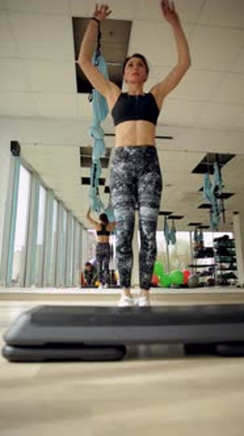 A Fit Woman Performs Various Exercises Showcasing Strength and Endurance in a Fitness Gym Vertical