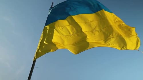 Ukrainian Flag Waving Against a Blue Sky