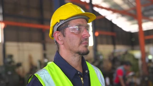 Factory male worker in plant production drilling at metal machine in industrial factory.
