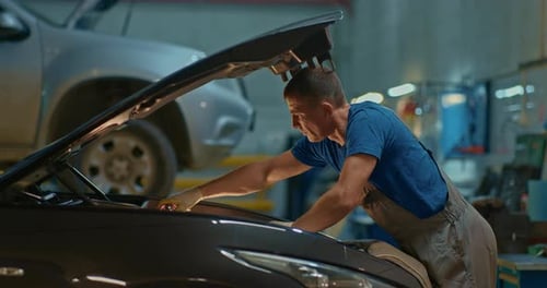 Car Mechanic Using Wrench to Repair the Engine Car Service