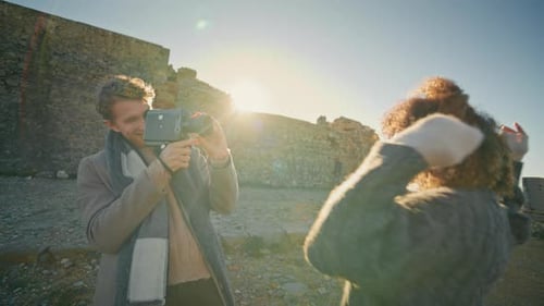 Couple Filming with Vintage Camera on Sunny Day