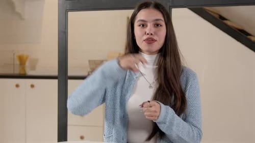 Woman Using Sign Language Indoors