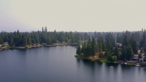 Beautiful Nature Scenery Of Calm Blue Water With Lush Green Trees In Pipe Lake, Washington, USA - Ti
