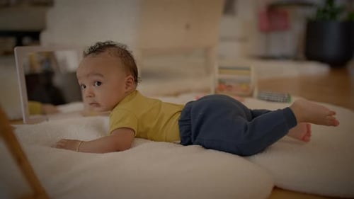 Adorable Infant on Stomach Looks at Mirror