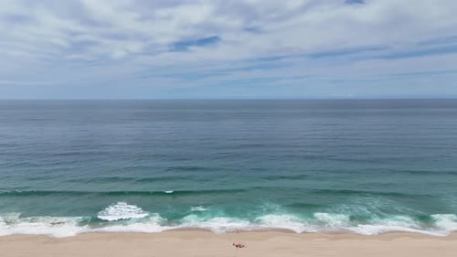 Experience the Serene Beauty of Tranquil Beach Waves Complemented By a Picturesque Sandy Shoreline