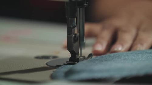 Close Up Of A Sewing Machine Working On A Denim