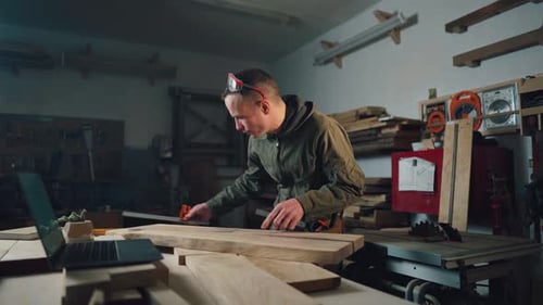 The Master Measures the Evenness of the Board in the Repair Shop