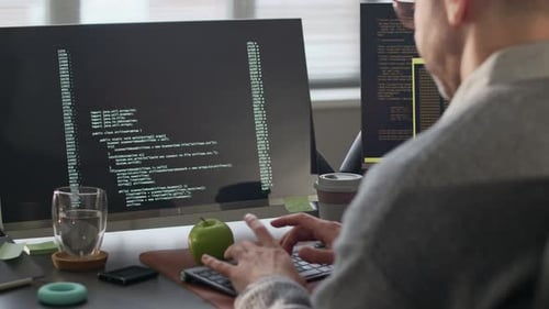 Male Programmer Working with Program Coding in Office at Daytime