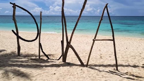 Puka Shell Beach Sign Made From Tree Branches on White Sand, Boracay Island, Philippines, Close Up