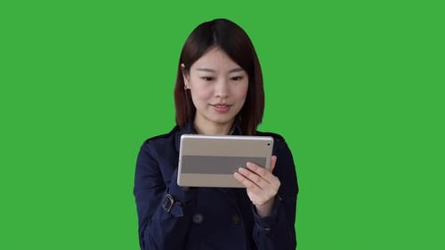 portrait of young asian women standing isolated against green screen background