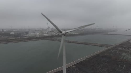 Aerial view of wind turbine blades rotating in a wind farm