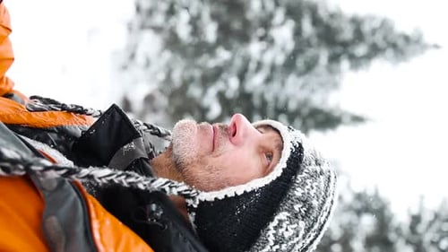 Man with Camera in Snowy Winter Wonderland