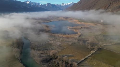 Aerial View of River in Foggy Rural Landscape