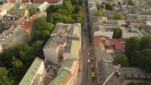 Aerial drone footage over the roofs of houses of the central street of old town of Krakow, Poland at