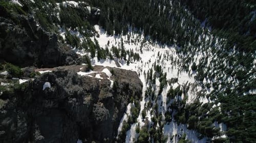 Downward Drone Flight Over Rocky Mountain Cliff