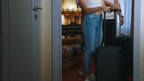 Couple with luggage arriving in a hotel room