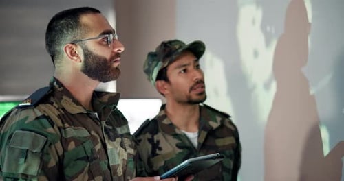 Men in Camouflage Uniform Pointing Indoors