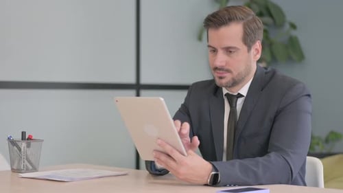 Cheerful Businessman using Tablet PC