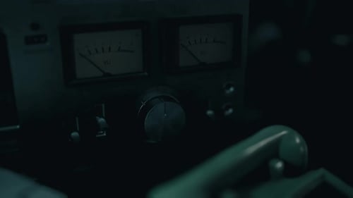Close Up View of Vintage Audio Equipment with Dials and Meters in Low Light