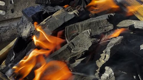 Charcoal Burning with Bright Orange Flames