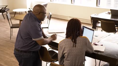 Business People with Laptop and Paperwork Meeting in Office 2529 Years