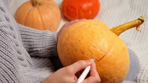 Drawing a Jack-O-Lantern Face on a Pumpkin