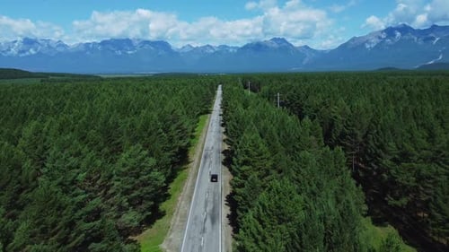 Above View of Transport Rides on Road in Countryside with Mountains Irrl