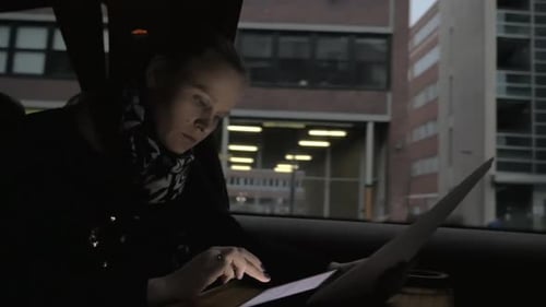 Woman Using Tablet in Car at Night