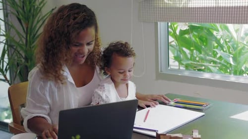 Woman Working From Home With Toddler