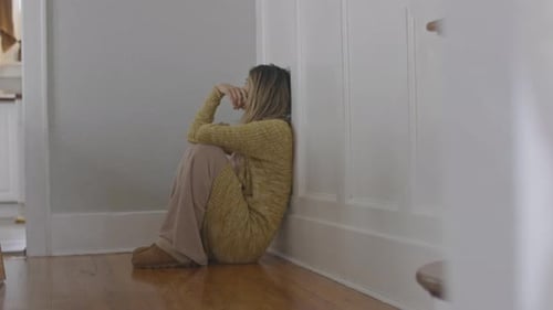 Woman Sitting Alone in Empty Room