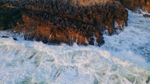 Dramatic Aerial Sea Crashing of Dark Coastal Rocks Closeup Ocean Waves Breaking