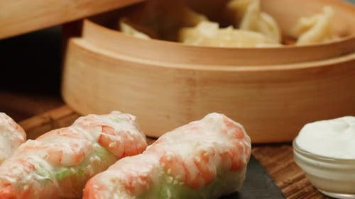Dimsun Gyoza Dumplings and Spring Rolls on Table Closeup Food Delivery Homemade Dishes
