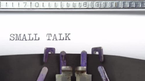 Small Talk phrase close up being typing and centered on a sheet of paper on old vintage typewriter