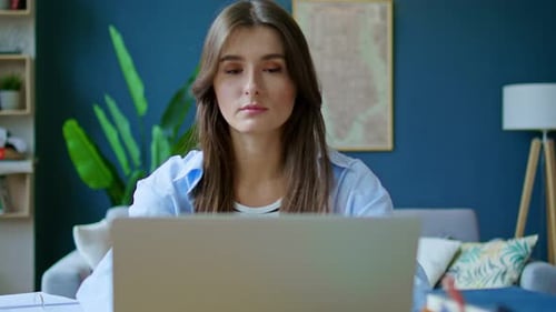 Woman Opens Laptop and Smiles in Modern Home
