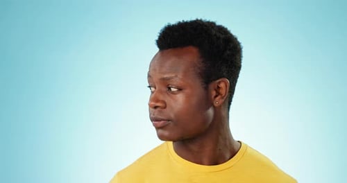 Black man, face and secret for gossip, whisper or privacy with finger on lips isolated on a blue