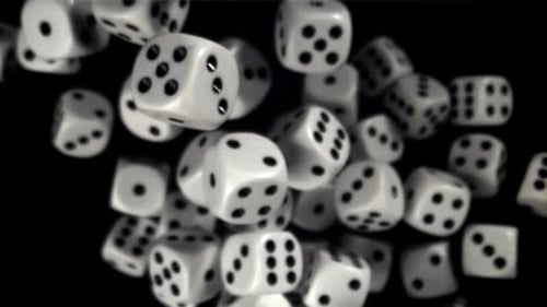 Rotating White Dice on Black Background