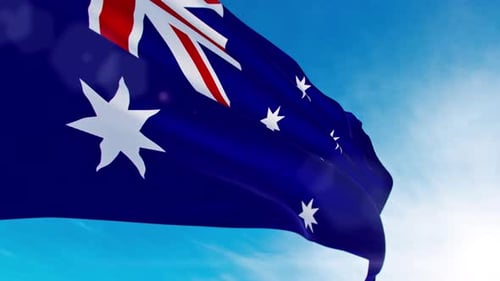 Waving Australian Flag Against Bright Blue Sky