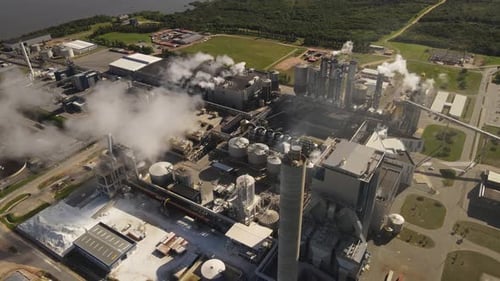Aerial orbit shot of Air Pollution Concept. Power Plant With Smoke From Chimneys - Drone shot