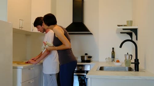 Adults in Modern Kitchen Preparing Food Together