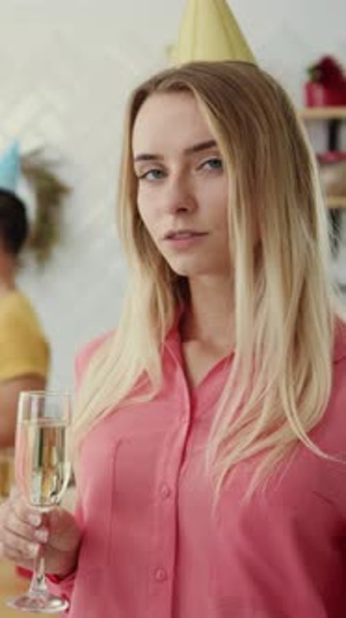 Smiling Woman Holding Champagne at Birthday Celebration