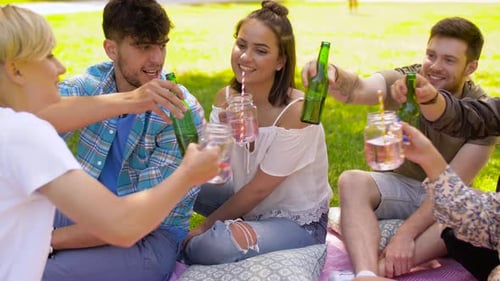 Leisure, People and Celebration Concept - Happy Friends Clinking Non Alcoholic Drinks
