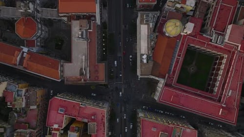 Birds Eye Shot of Car Driving on Multilane Road Between Old Town Development with Historic Landmarks
