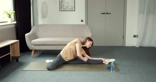 Woman Stretching in Home Gym for Fitness