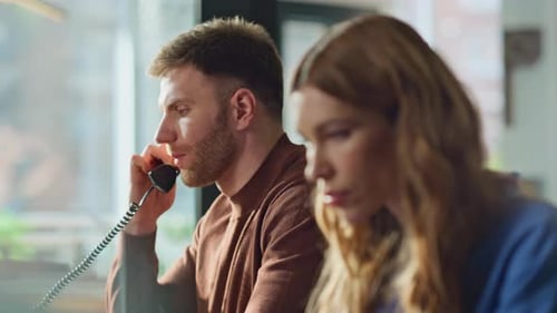 Help Desk Operators Talking Phone in Office Workplace Closeup Two Specialists