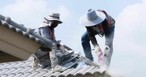 Two man builder working on roof of new house. Man worker working on roof structure of building