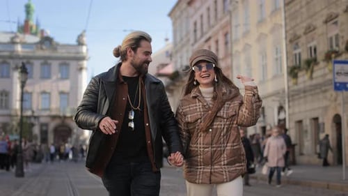 Positive Couple Chating and Walking on City Street