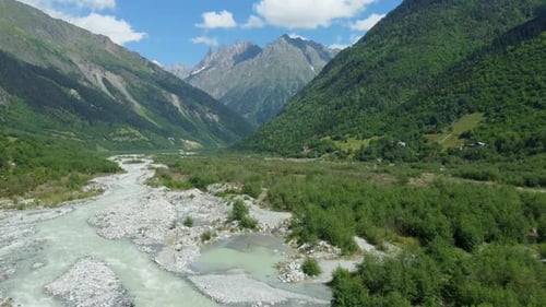 Breathtaking mountain valley with winding river and lush greenery
