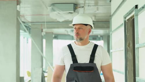 Confident 50s Builder Engineer Architect Walk on a Construction Site Construction Worker at Modern